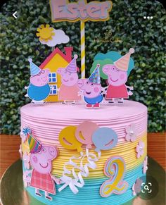 a birthday cake decorated with peppa the pig characters