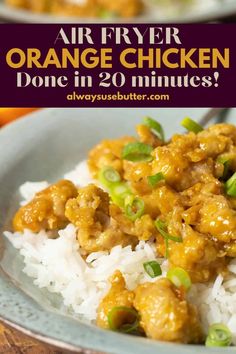 an orange chicken dish with white rice and green onions on the side in a blue bowl