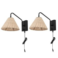 two black wall lights with wicker shades on each side and one light attached to the back