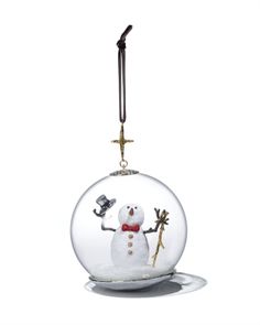 a glass ornament with a snowman in it on a white background,