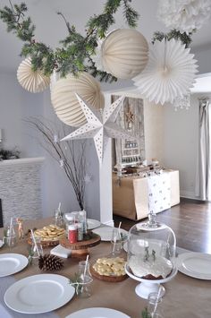 a dining room table with plates and cups on it, decorated for christmas or new year's eve