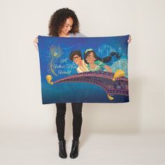 a woman holding up a disney poster