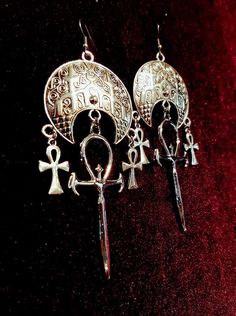 Vampire Ankh Cathedral Earring. - Available in 2 styles. - Stunning vampire ankh. (6cmx3cm) - 2 Small Ankhs - Moon Cathedral-like ornament. Style 1: With connector above the big vampire ankh. Style 2: Without connector above the big vampire ankh. Worldwide Shipping More jewellery, accesoires, altar equipment and much more can be found at www.luciferothica.com © Luciferothica.com All Rights Reserved. Cathedral Earrings, Vampire Ankh, Vampire Earrings, Ankh Symbol, Gothic Jewellery, Ankh Necklace, Goth Accessories, Edgy Earrings, Goth Earrings