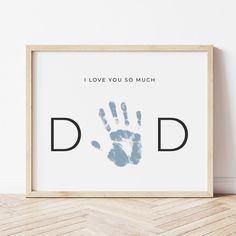 a framed print with the words i love you so much and a handprint on it