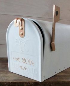 a white mailbox sitting on top of a wooden table