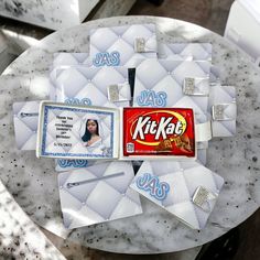 a table topped with lots of cards and a candy bar on top of each other