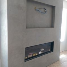 a modern fireplace in the middle of a room with no one around it or on the wall