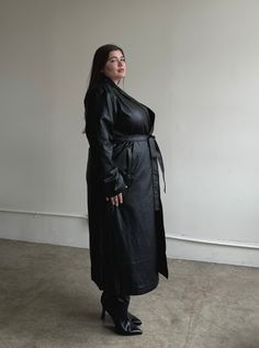 Look your best in this timeless Plus Size Faux Leather Trench Coat. Made out of a luxurious faux leather, it features a flattering fit and double pockets for an added touch of style. You'll make a lasting impression in this sophisticated coat! This coat features a folded-down collar, a tie around the waist, double pockets, and a long length. The material is a super soft faux leather. This coat is made out of 70% Polyurethane and 30% Rayon and a lining that is 100% Polyester. Imported. Hand wash Photos With Mom, Plus Size Trench Coat, Faux Leather Trench Coat, Long Leather Coat, Nice Women, Leather Coats, Leather Trench, Car Coat, Trench Coat Black