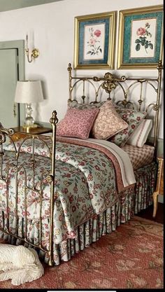 a bed room with a neatly made bed and a dog laying on the floor next to it