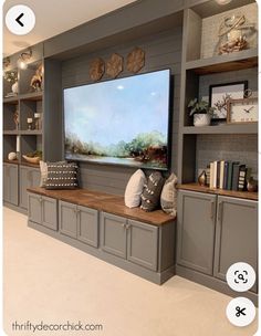 a living room filled with lots of gray furniture