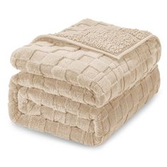 three towels stacked on top of each other in different sizes and colors, one is beige