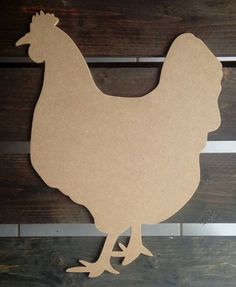 a cutout of a chicken on a wooden surface