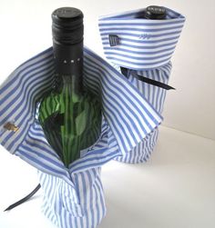 a wine bottle wrapped in blue and white striped paper with a black cap on top