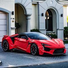 a red sports car parked in front of a house