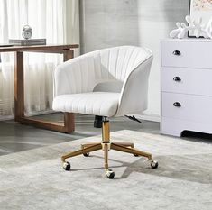 a white office chair sitting on top of a carpeted floor next to a dresser