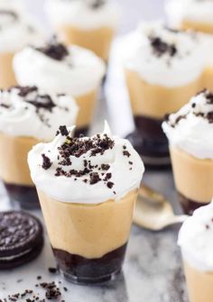 mini desserts with white frosting and oreo cookies on the side, ready to be eaten