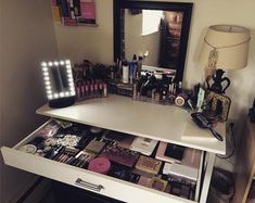 the vanity is full of cosmetics and makeup products