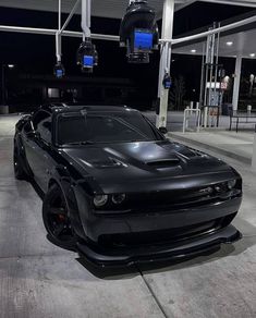 a black sports car parked in a parking garage