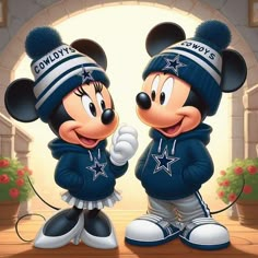 two mickey mouses dressed in blue and white outfits, standing next to each other