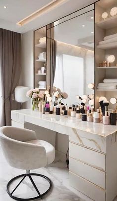 a white chair sitting in front of a vanity with lots of makeup on top of it