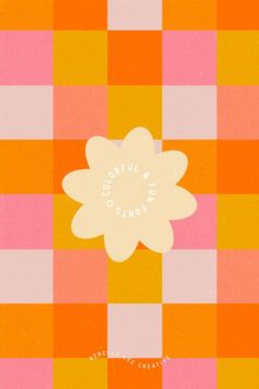 an orange, pink and yellow checkered table cloth with a flower on it's center