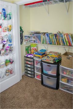 a room with several bins and shelves filled with books