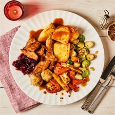 a white plate topped with meat and vegetables