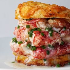 there is a sandwich with lobster and cheese on it