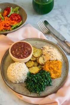 a plate with rice, beans and vegetables on it