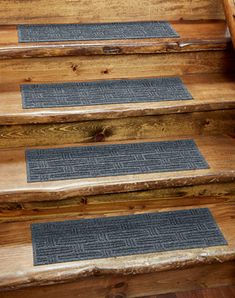 the steps are made out of wood and have blue mats on them