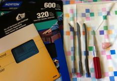 several different items are laid out on a table top, including a credit card and pens