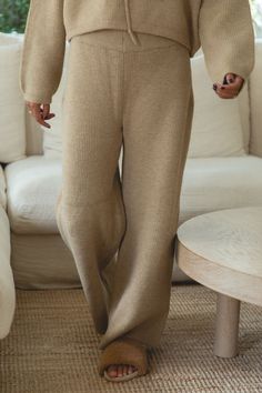 These Autumn Wave knit sweater pants are made with a soft camel knit fabric for a cozy and stylish look. Perfect for cooler weather, these pants offer a warm and comfortable fit. With a relaxed silhouette and classic design, these pants are a must-have for any fall wardrobe. Comfy Pants With Ribbed Cuffs, Cozy Pants With Ribbed Cuffs For Everyday, Beige Stretch Sweatpants For Fall, Cozy Lounging Pants With Ribbed Cuffs, Winter Beige Relaxed Fit Sweatpants, Cozy Soft Pants For Winter, Winter Solid Color Wide-leg Sweatpants, Soft Texture Pants For Fall Loungewear, Cozy Soft Texture Winter Pants