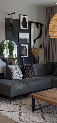 a living room filled with lots of furniture next to a large mirror on the wall