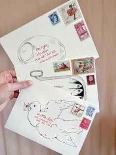 someone is holding up some stamps on top of a piece of paper with an image of a chicken