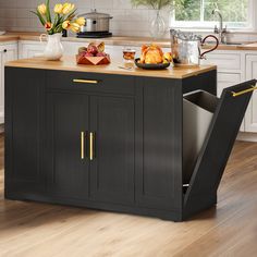 a kitchen island with an open trash can