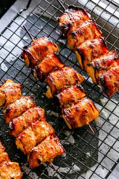 several skewers of meat on a grill