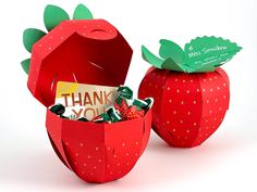 two paper strawberries with thank you notes in them