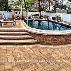 an above ground pool with steps leading up to it and two lawn chairs next to it