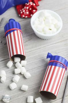 two paper roll marshmallows sitting on top of a wooden table