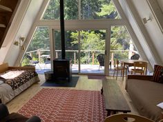 a living room filled with furniture and a fire place in the middle of a room