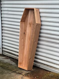 a wooden object sitting on the side of a building