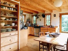 a kitchen with wooden walls and cabinets filled with dishes