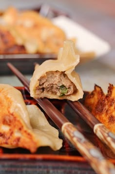 spicy beef dumplings with garlic sauce are on the grill and ready to be eaten