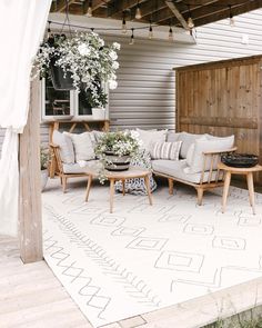 an outdoor living area with couches and tables