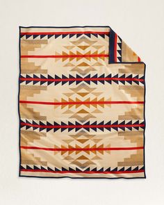 an old native american blanket with red, white and blue designs on it's edges