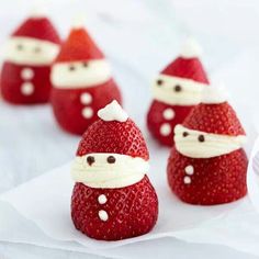 some strawberries with santa hats on them are sitting in the shape of santa claus