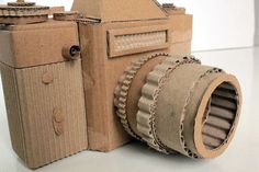 an old camera made out of cardboard sitting on a table