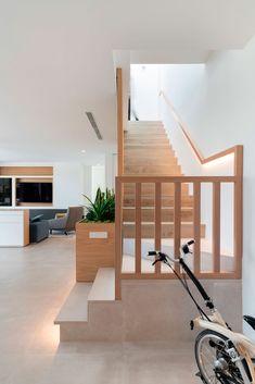 a bicycle is parked in front of the stairs and railings that lead up to the second floor