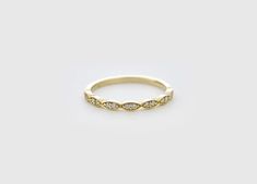 a yellow gold ring with diamonds on it