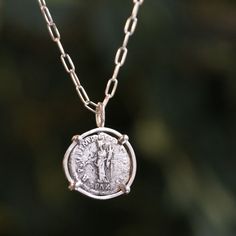 In antiquity. Carry a piece of the past with you with this stunning roman coin necklace. The coin is a genuine Roman silver piece was minted between 97 AD and 300 AD. The Roman Silver Denarius is among the most iconic and sought coins in the eyes of ancient coin collectors. The denarius is a small coin, about the size of an American nickel, and had the value of 10 asses, indicated by the roman root word dēnī, or “containing ten”. The coin was considered by scholars to be Rome’s main coin, until Ancient Roman Coins, Silver Coin Necklace, Ancient Coin, Alt Style, Roman Coins, Crystals In The Home, Cuff Rings, Ancient Coins, Tourmaline Ring